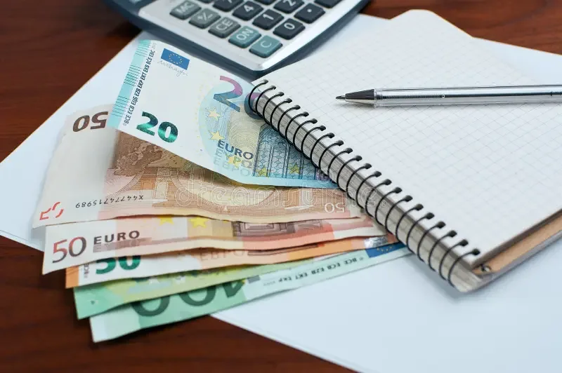Billets en euros, calculatrice et carnet pour contrôler le montant réellement débité